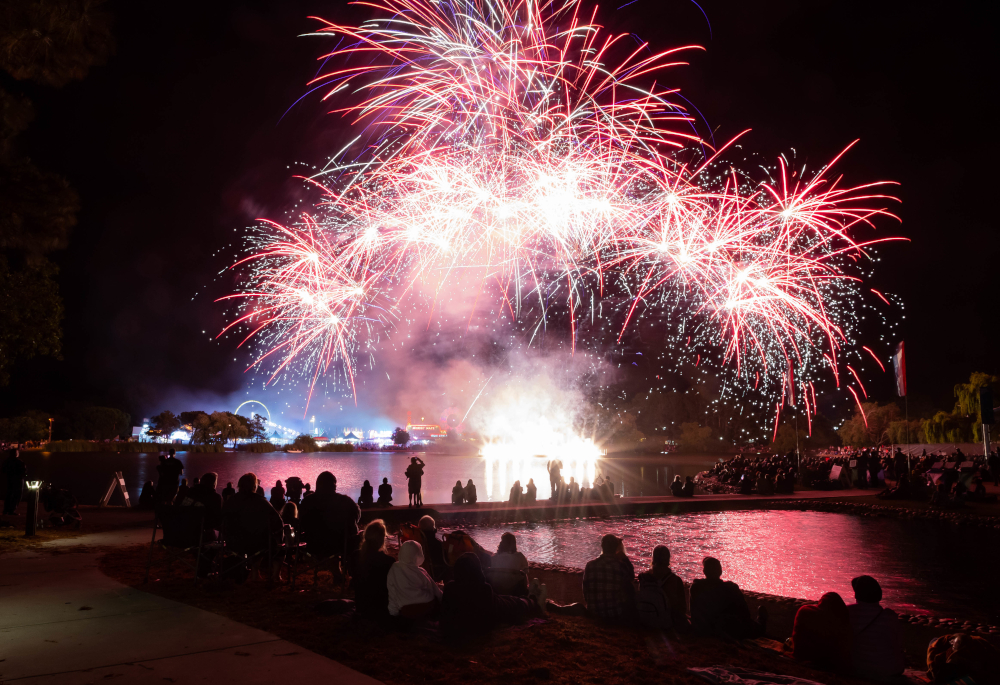 Fireworks, fairgoers, carnival across lagoon